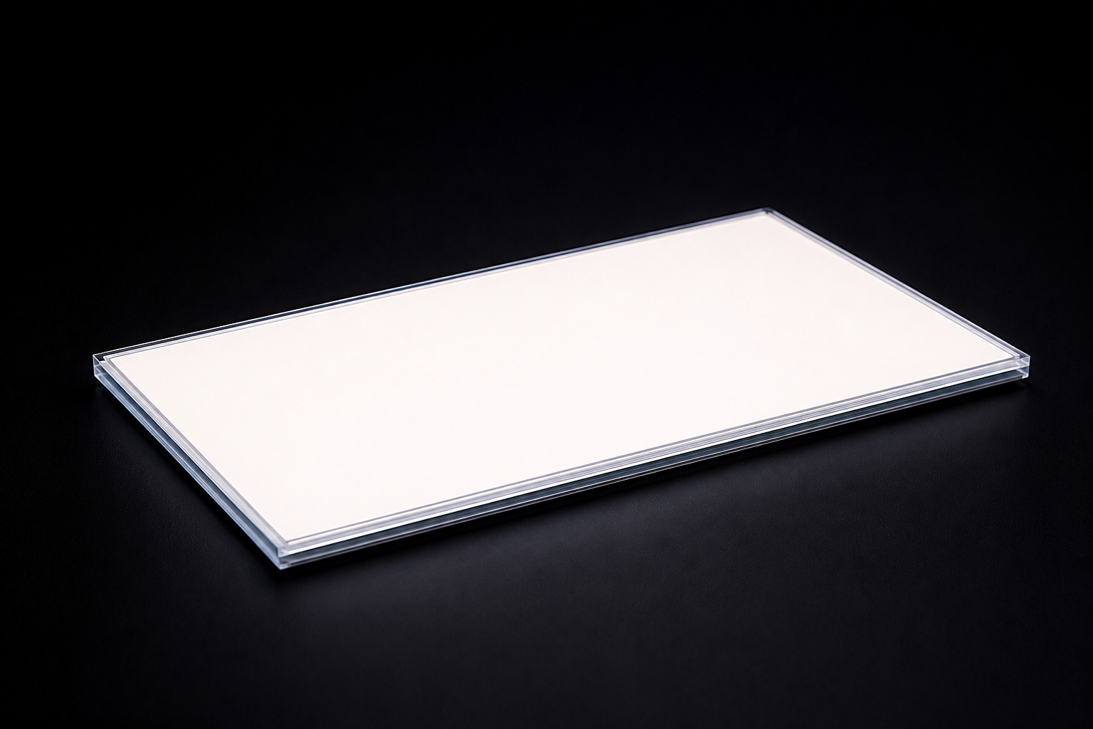A backlight module lit in the dark — the light-guide dot pattern visible across the panel